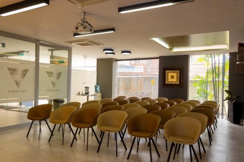 a room with a row of chairs in a room at VVC Hotel's in Villavicencio
