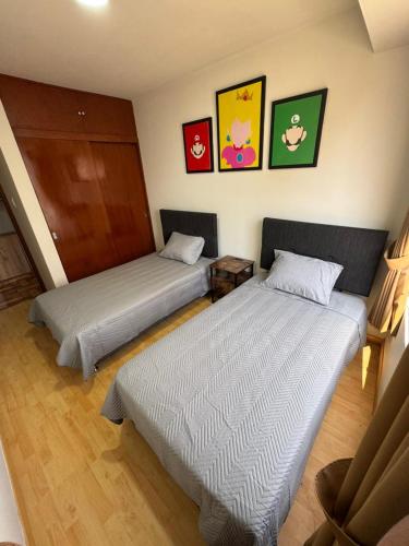 Ένα ή περισσότερα κρεβάτια σε δωμάτιο στο Solena Apartamentos Tacna