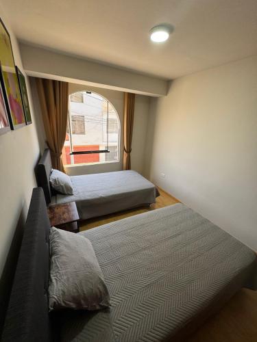 Ένα ή περισσότερα κρεβάτια σε δωμάτιο στο Solena Apartamentos Tacna