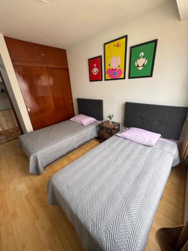 Ένα ή περισσότερα κρεβάτια σε δωμάτιο στο Solena Apartamentos Tacna