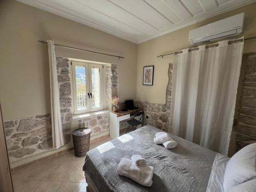 a bedroom with a bed and a window at Mythic Gem in Vathi, Ithaka