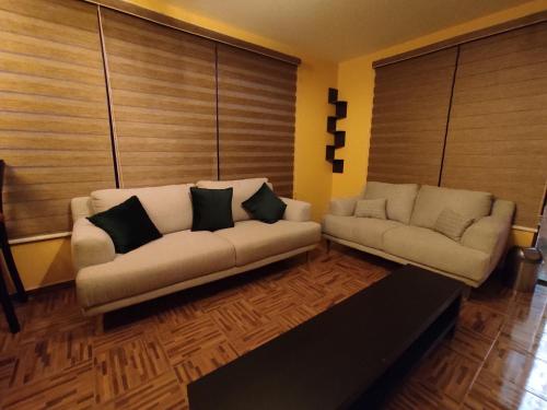 a living room with two couches and a couch at Posada Familiar Lupita in Texcoco de Mora