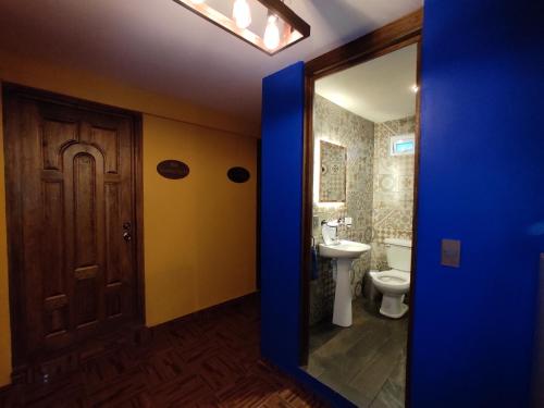 a bathroom with a toilet and a sink and a mirror at Posada Familiar Lupita in Texcoco de Mora