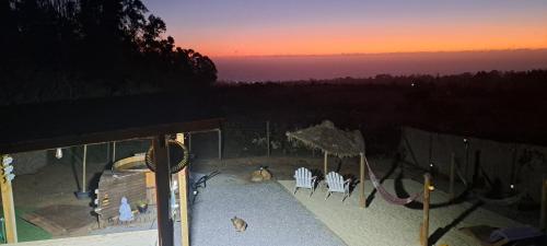 a view of a patio with chairs and a swing at Algarrobo Tinaja Caliente Privada Lista para Disfrutar in Tunquen