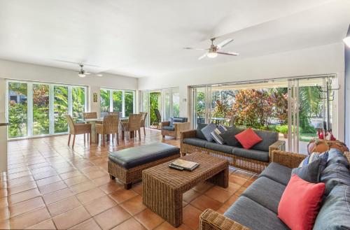 a living room with a couch and a table at Balboa Apartments in Port Douglas