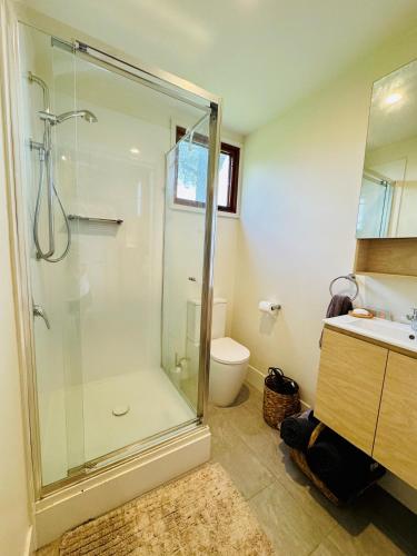 a bathroom with a shower and a toilet and a sink at Charming Studio in Somersby in Somersby