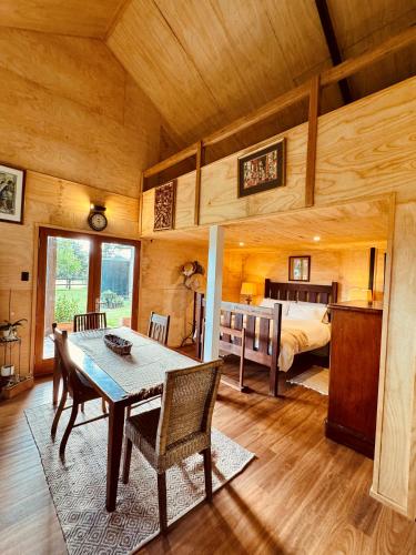 a room with a table and a bed and a bedroom at Charming Studio in Somersby in Somersby