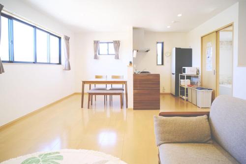 a living room with a couch and a table at 渡 - Duo Okinawa in Onna