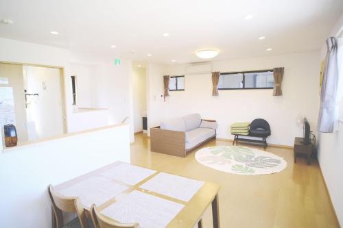 a living room with a table and a couch at 渡 - Duo Okinawa in Onna