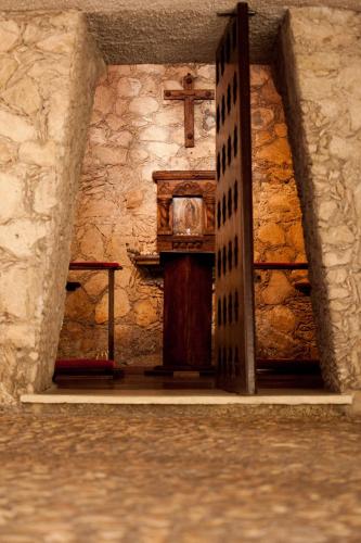 a church with a cross and a wooden door at Hotel Tucan Siho Playa in Sihoplaya