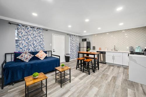 a living room with a bed and a kitchen at Quirky & Chic 1BR Near Montrose & River Oaks! in Houston
