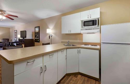 a kitchen with white cabinets and a microwave at Extended Stay America Suites - Madison - Junction Court in Middleton