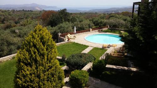 an image of a swimming pool in a garden at Stratos Villas in Melidhónion