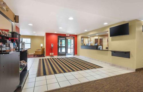 a large room with a lobby with red walls at Extended Stay America Suites - Princeton - West Windsor in Princeton