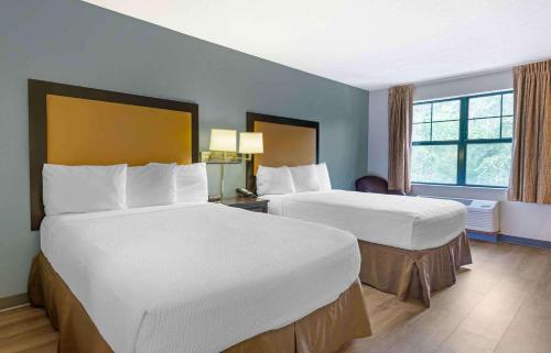 a hotel room with two beds and a window at Extended Stay America Suites - Princeton - West Windsor in Princeton