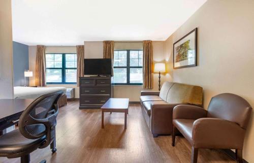 a living room with a couch and a television in a room at Extended Stay America Suites - Princeton - West Windsor in Princeton