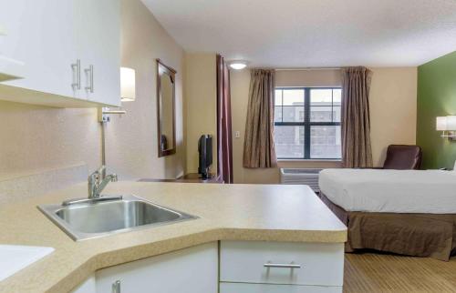 a kitchen with a sink and a bed in a room at Extended Stay America Suites - Columbus - NE - I-270 in Gahanna