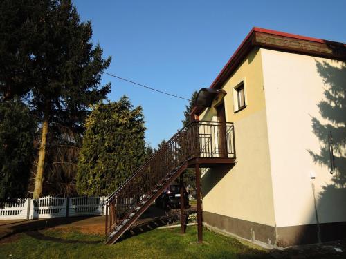 a staircase leading up to a building with a tree at Holiday Home in Stepnica near Szczecin Lagoon in Stepnica