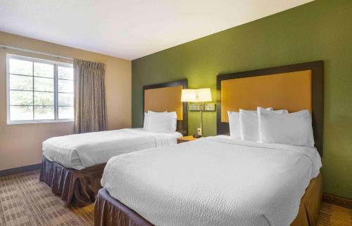 a hotel room with two beds and a window at Extended Stay America Suites - Louisville - Alliant Avenue in Louisville