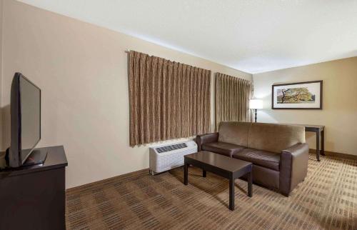 a living room with a couch and a television at Extended Stay America Select Suites - Orlando - Lake Mary - 1040 Greenwood Blvd in Lake Mary