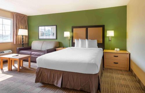 a hotel room with a large bed and a couch at Extended Stay America Suites - Philadelphia - Malvern - Swedesford Rd in Malvern