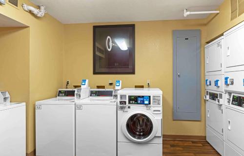 a laundry room with a washing machine and a tv at Extended Stay America Suites - North Chesterfield - Arboretum in Richmond