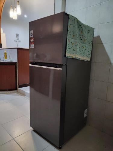 a refrigerator in a kitchen with a towel on it at Spacious Bungalow with Large Outdoor in Sabah in Penampang