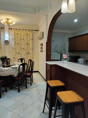 a kitchen and dining room with a table and chairs at Spacious Bungalow with Large Outdoor in Sabah in Penampang