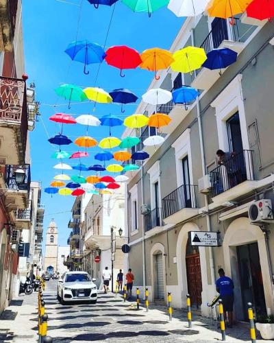 a bunch of colorful umbrellas hanging over a street at B&B La Casa Di Bianca in Manfredonia