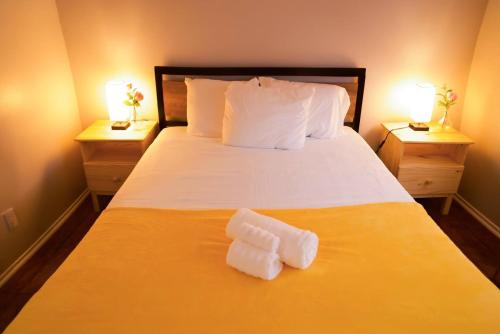 a bedroom with a large bed with two nightstandiatesiatesiatesiatesiatesiates at Enchanting Garden with Luxe Jacuzzi Spacious Yard in Las Vegas