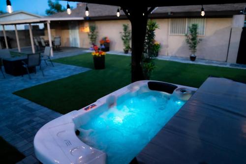 a hot tub in the middle of a yard at Enchanting Garden with Luxe Jacuzzi Spacious Yard in Las Vegas