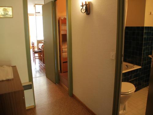 a bathroom with a toilet and a door to a room at Apartment for 4 people in Chatel in Châtel
