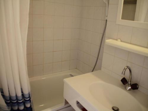 a white bathroom with a sink and a shower at Jonquilles apartment for 4 people in Châtel