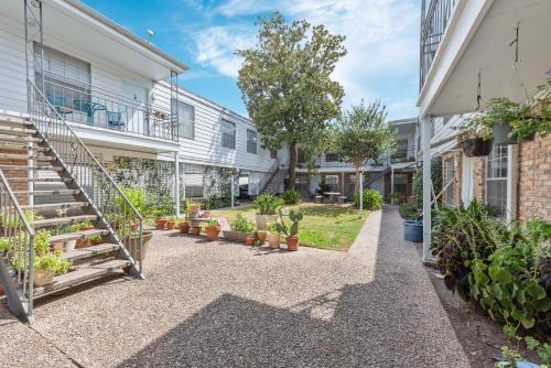a courtyard of a building with potted plants at Cozy Studio Escape Near Montrose in Houston