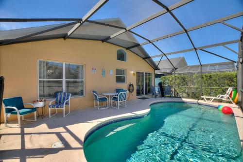 an indoor swimming pool with a glass ceiling at Luxe 3BR 2BA Oasis with Pool & Designer Touches, Disneyland, Legoland in Haines City