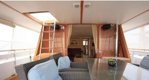 a living room with a glass table and chairs at Johnny M Yacht Private in Il-Gżira