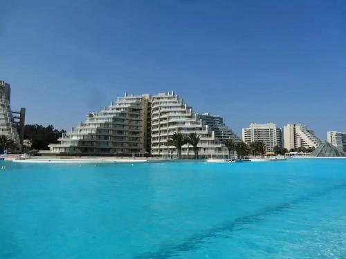 a view of a large building from the water at San Alfonso del mar ,gran vista in Algarrobo