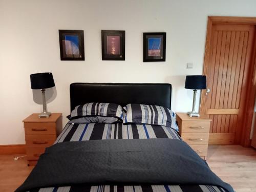 a bedroom with a bed with two night stands and two lamps at The Studio in Dublin