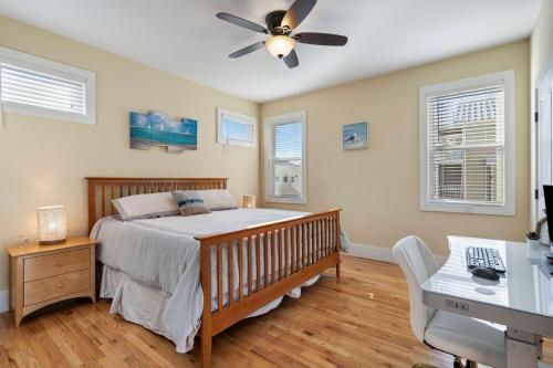 a bedroom with a bed and a ceiling fan at Turtle Cove Beach Retreat GOLF CART Included in Carolina Beach