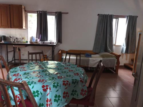 a kitchen with a table with a flowered table cloth at El loft de Marce in Oberá