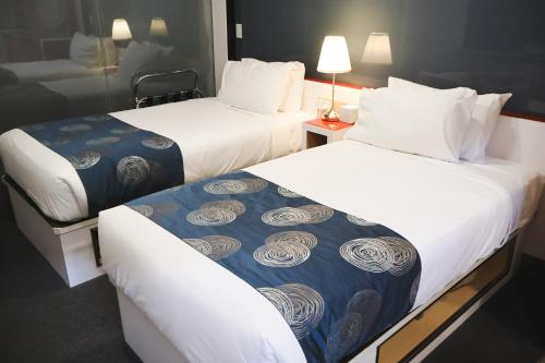 Postel nebo postele na pokoji v ubytování Stay Motel - Formerly Room Motels Gympie