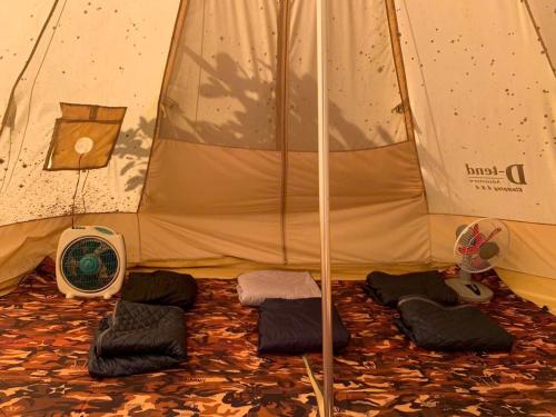 a tent with a group of pillows in it at Meeto Camping Hồ Trị An in Ấp Vĩnh An Số