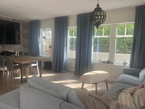 a living room with a couch and a table at Solbacken 59 in Landvetter