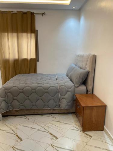 a bedroom with a bed and a wooden table at maison cotiére in Iterkine