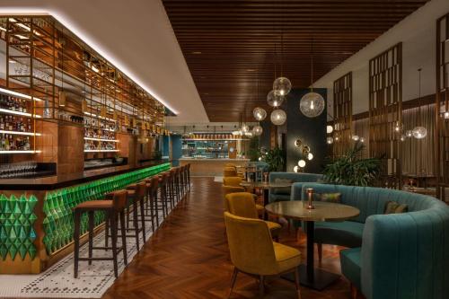 a restaurant with tables and chairs and a bar at JW Marriott Mumbai Juhu in Mumbai
