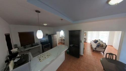 a living room with a large white couch and a living room at Beach House in Tela with a Pool in Tela
