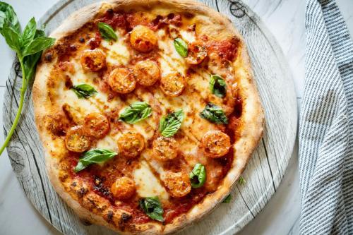 a pizza on a glass plate on a table at Sheraton Puerto Rico Resort & Casino in San Juan