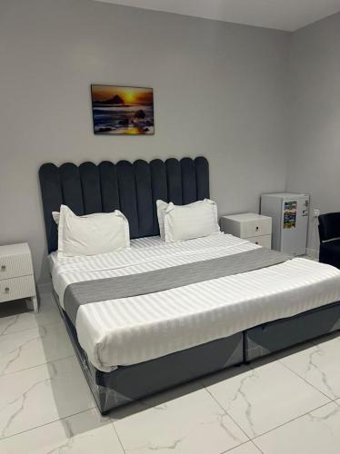 a large bed in a room with a large mattress at skoon rest hotel in Hafr Al Baten
