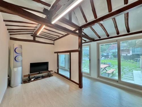 a large living room with a flat screen tv at Hongcheon Hanok Stay Scenery in Hongcheon