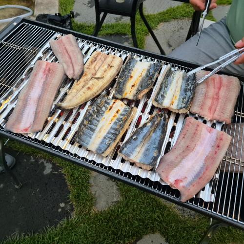 a grill with several different types of meat on it at Hongcheon Hanok Stay Scenery in Hongcheon